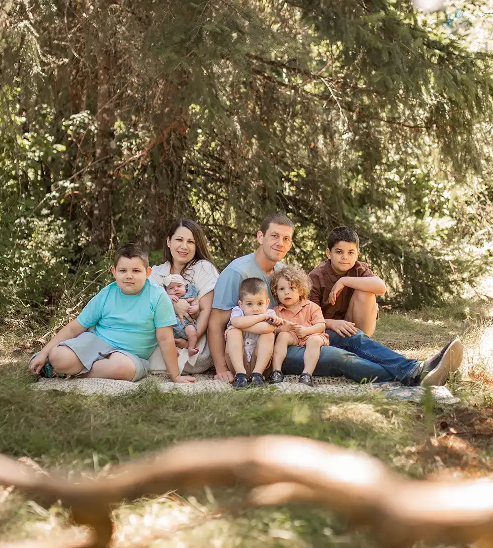 Stephen and Jessica Douglas, owners of Priority Tree Service, with their family